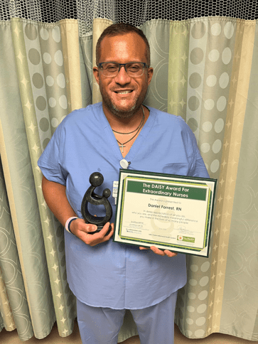 Timothy Daniel Forrest holding award